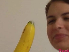 How-to young brunette girl teaches using a banana