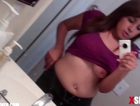 Busty teen girl taking a video selfie