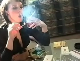 Older doxy holding a cigarette and playing with herself